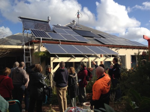 Admiring the solar PV, vacuum tubes and wind turbine on Martin's north facing roof