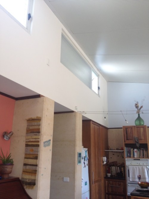 Roof/ceiling us cool room panels for weight and thermal efficiency High clerestory windows have bubble wrap for extra insulation and can open to release excess hot air Note timber at the top of the rammed earth that can be used as a picture rail.